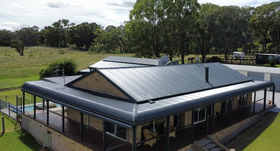 Rural home roof recoated a clean terracotta red