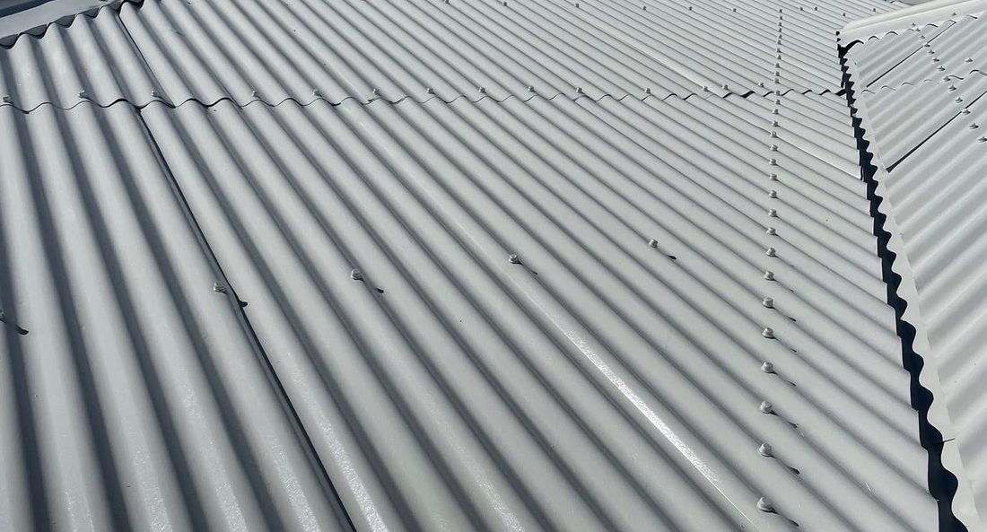 Heavily rusted iron roof resprayed bright white