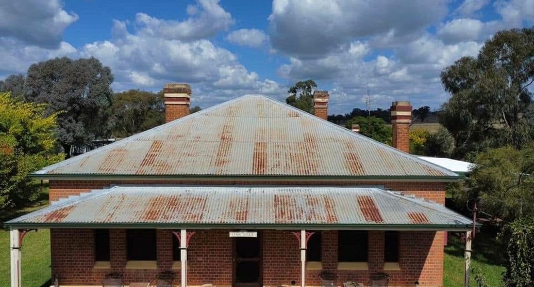 Rusted iron roof on a heritage homestead before restoration