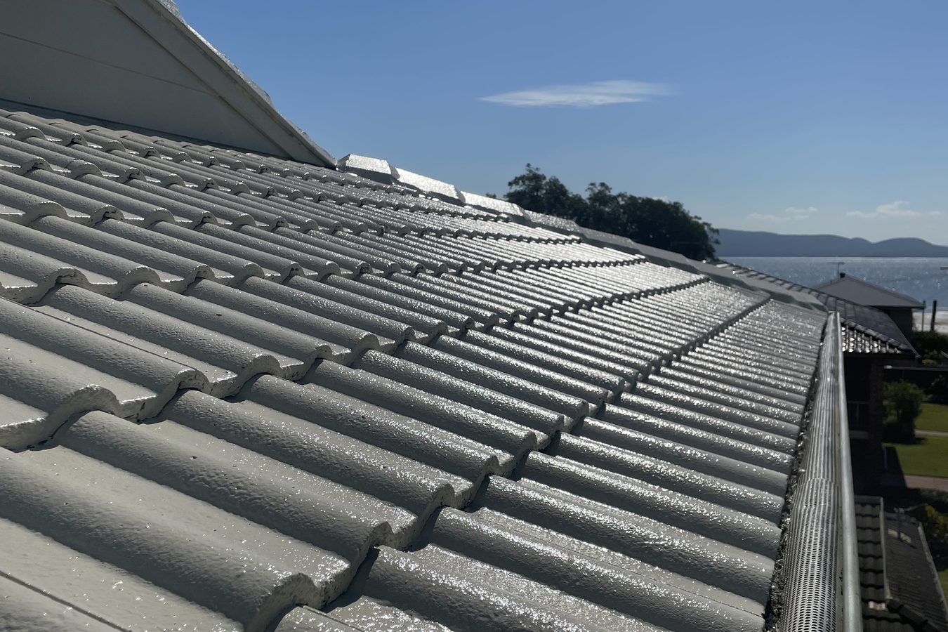 Coastal home with a glossy restored tile roof